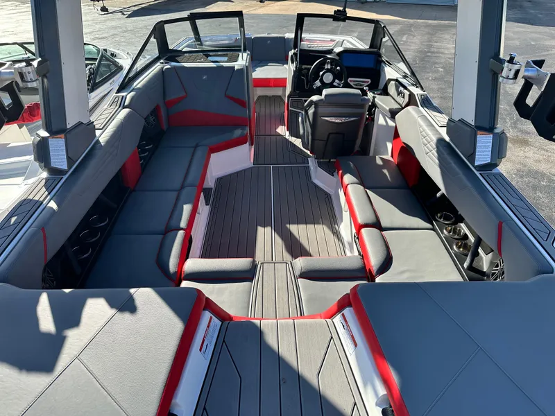 Slide: The Image of 2022 Nautique S23 boat interior with sleek seating and modern dashboard design. - 6