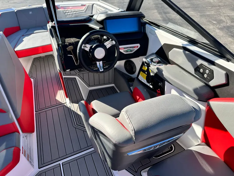 Slide: The Image of 2022 Nautique S23 boat interior with modern dashboard and seating. - 7