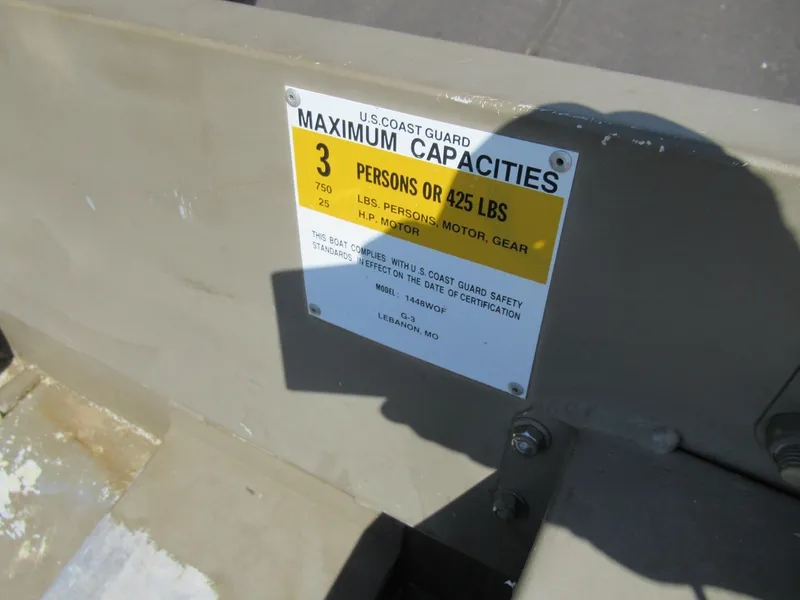 Slide: The Image of U.S. Coast Guard capacity label on 2012 G3 1448 WOF boat, indicating 3 persons or 425 lbs. - 10