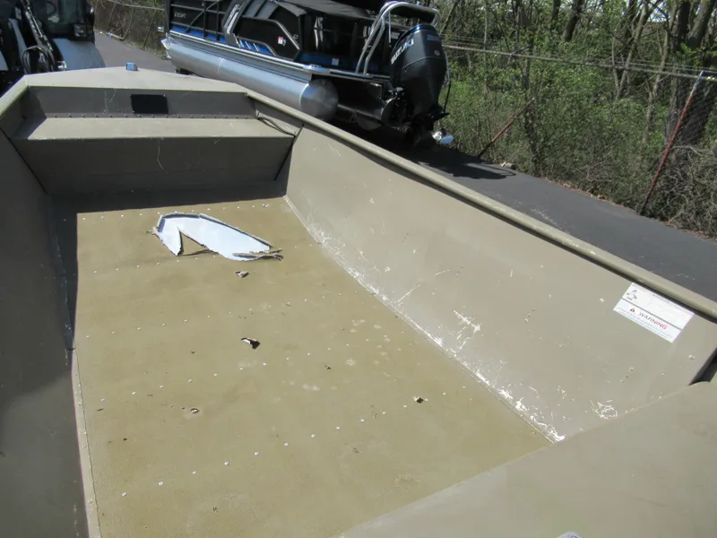 Slide: The Image of 2012 G3 1448 WOF boat interior with visible wear and debris. - 11