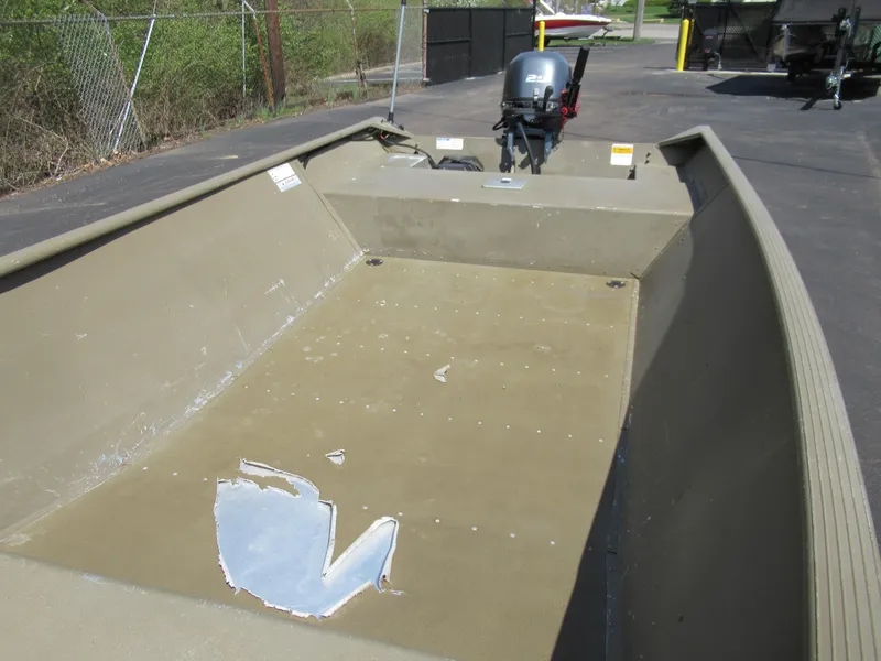 Slide: The Image of 2012 G3 1448 WOF boat with motor, parked on pavement. - 13