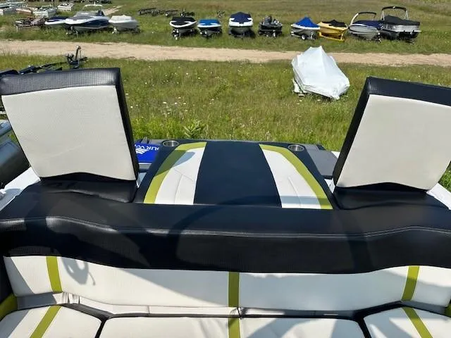 Slide: The Image of 2016 Four Winns H180 boat interior with black and white seating, outdoor setting. - 19