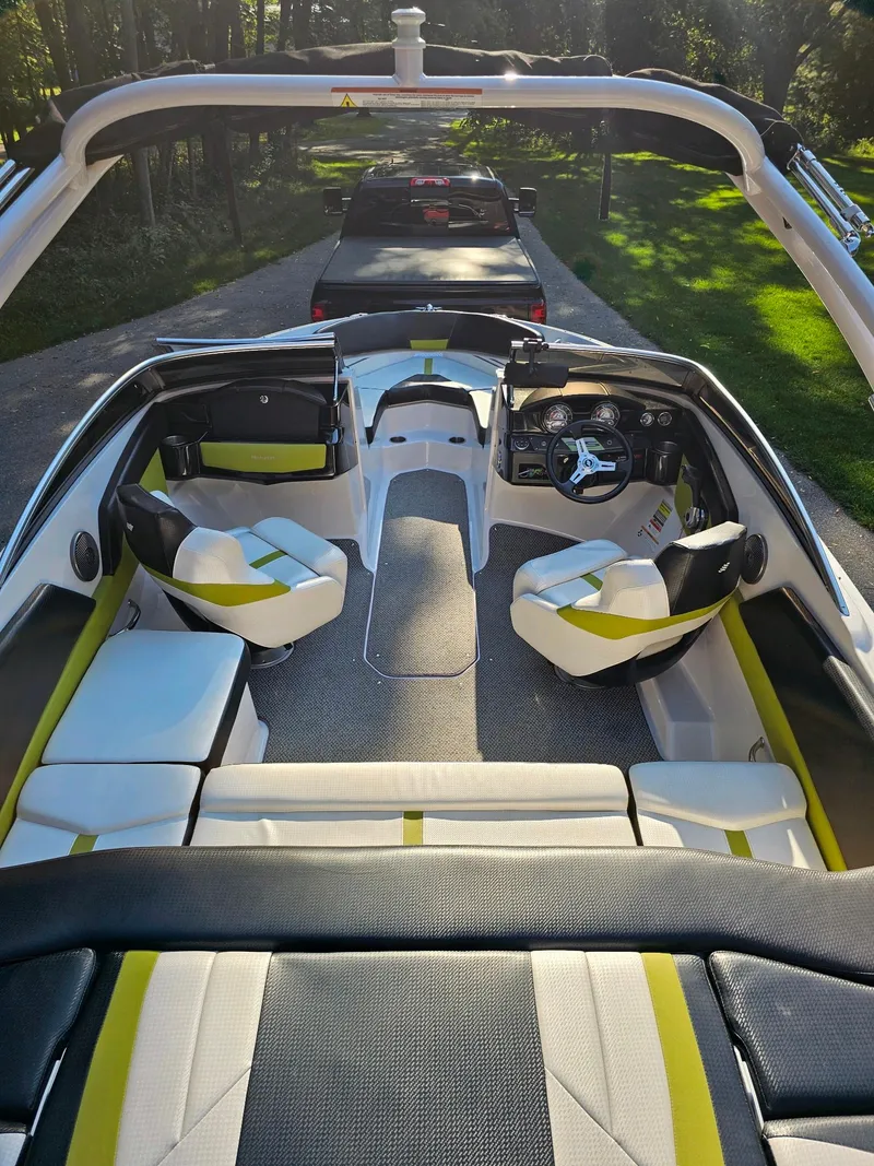 Slide: The Image of 2016 Four Winns H180 boat interior with modern seating and dashboard. - 21