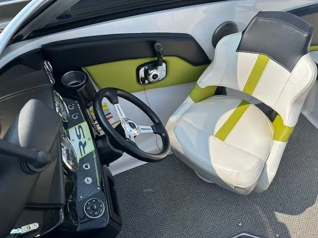 Slide: The Image of Interior of 2016 Four Winns H180 boat with steering wheel and seat. - 8