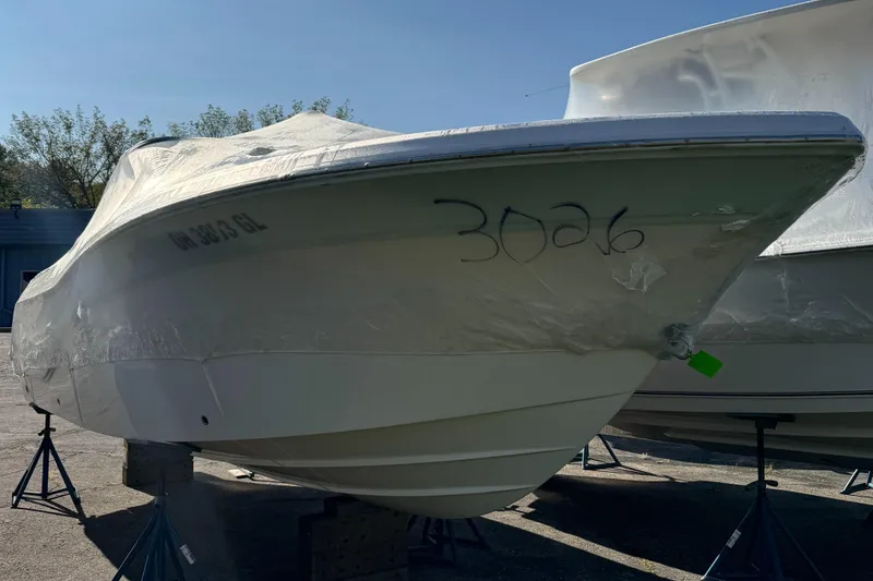 Slide: The Image of 2024 Sea Fox 226 Traveler boat covered and stored on stands outdoors. - 1