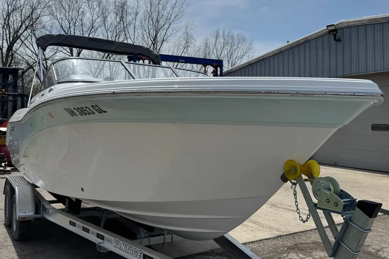 Slide: The Image of 2024 Sea Fox 226 Traveler boat on trailer, parked outdoors near a building. - 10