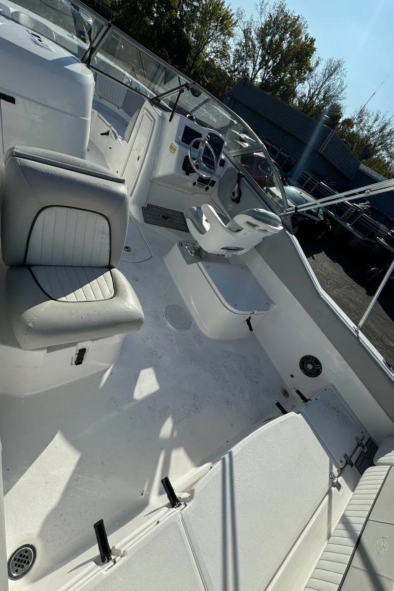 Slide: The Image of 2024 Sea Fox 226 Traveler boat interior with seating and steering wheel. - 7
