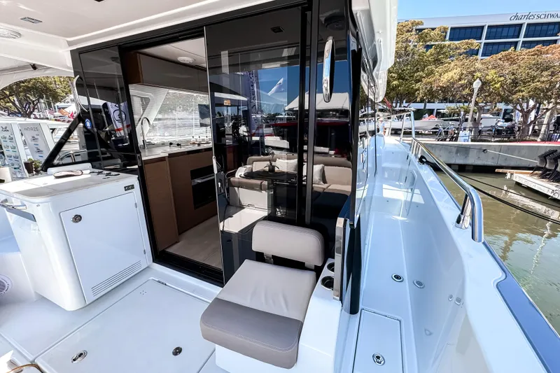 Slide: The Image of 2026 Wellcraft 44 Explorer yacht with modern interior and harbor view. - 2