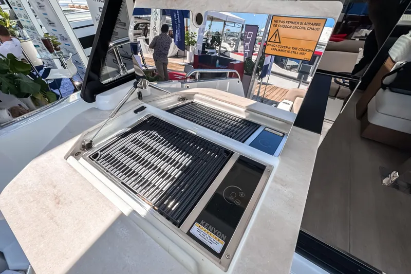 Slide: The Image of Wellcraft 44 Explorer 2026 kitchen area with grill and warning sign. - 3