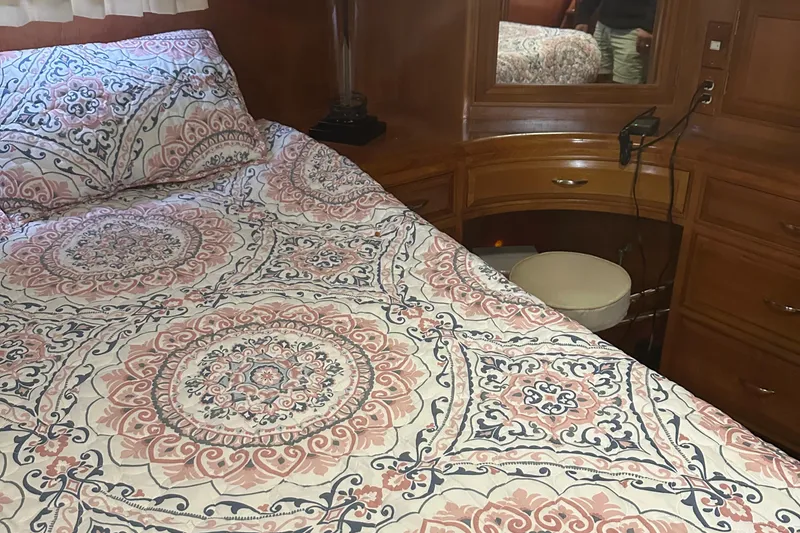 Slide: The Image of Cozy bedroom in 1988 Ocean Alexander 42 aft cabin yacht with patterned bedding. - 13