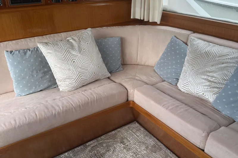 Slide: The Image of Cozy seating area with patterned cushions on 1988 Ocean Alexander 42 aft cabin yacht. - 14