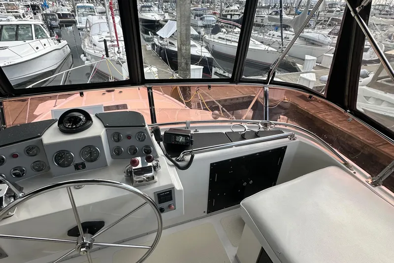 Slide: The Image of 1988 Ocean Alexander 42 aft cabin yacht helm with marina view. - 18