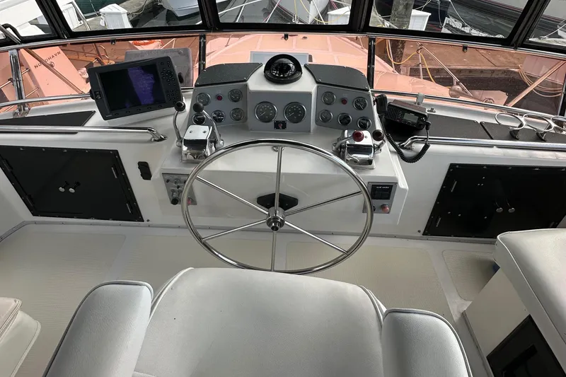 Slide: The Image of 1988 Ocean Alexander 42 aft cabin helm with steering wheel and navigation equipment. - 19