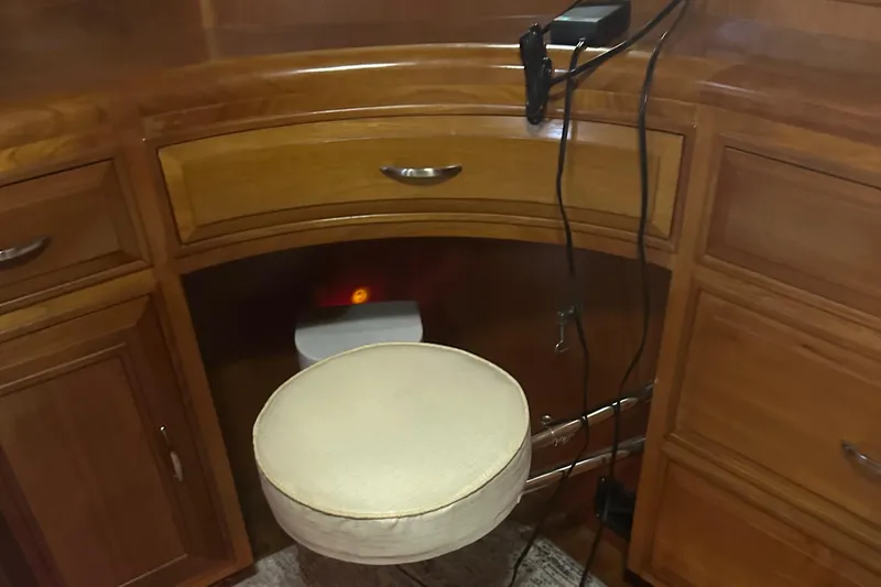 Slide: The Image of 1988 Ocean Alexander 42 aft cabin interior with wooden cabinetry and cushioned stool. - 8