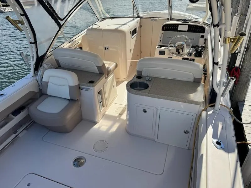 Slide: The Image of 2014 Grady-White Freedom 307 boat interior with seating and helm. - 13