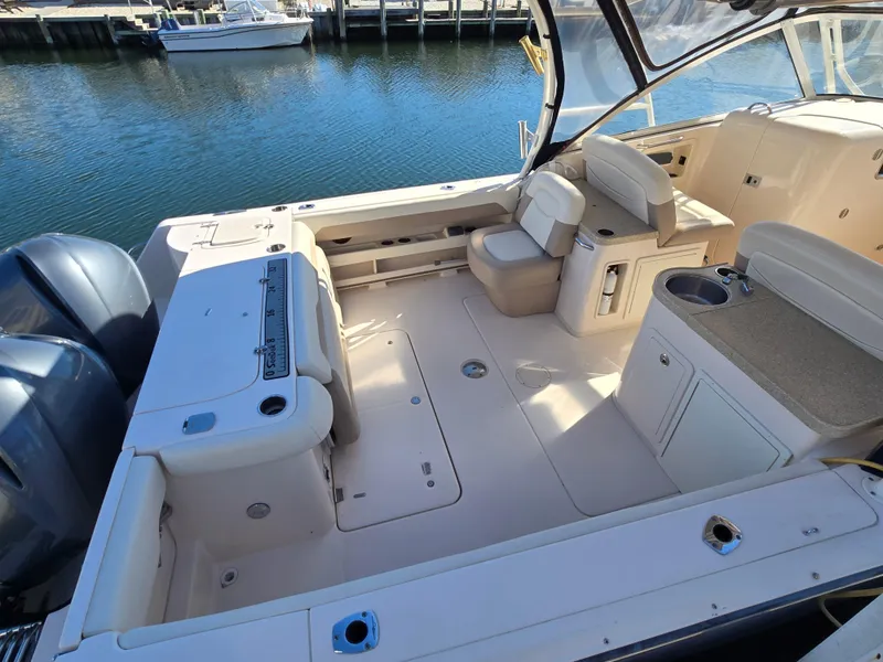 Slide: The Image of 2014 Grady-White Freedom 307 boat interior with seating and water view. - 14