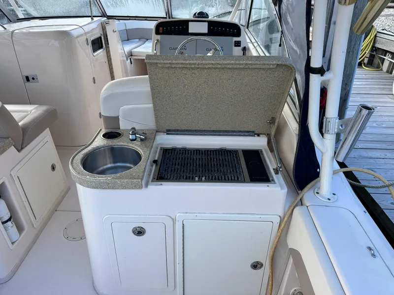 Slide: The Image of 2014 Grady-White Freedom 307 boat interior with sink and grill station. - 15
