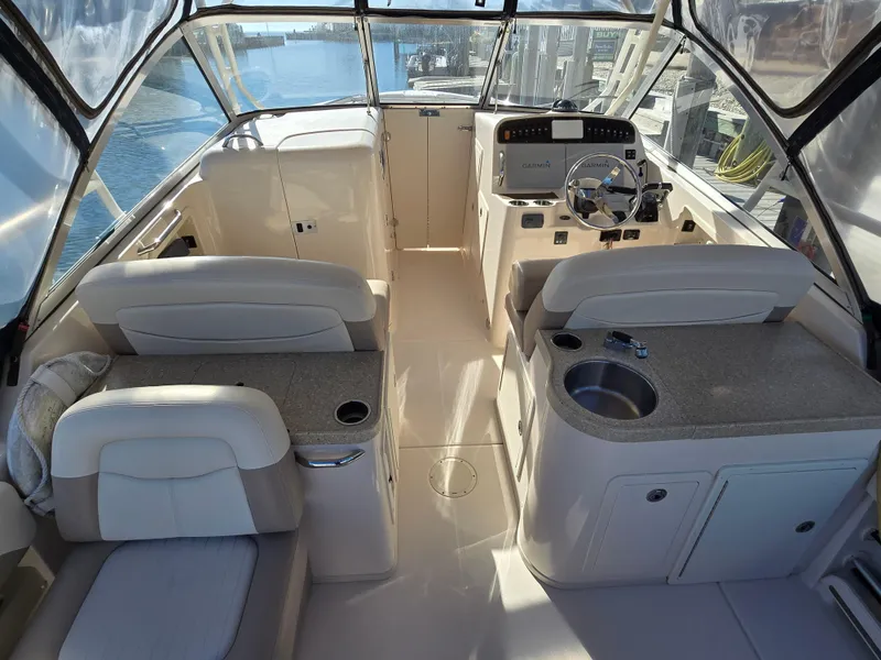 Slide: The Image of 2014 Grady-White Freedom 307 boat interior with helm, seating, and sink. - 17
