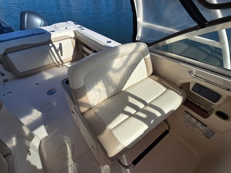 Slide: The Image of 2014 Grady-White Freedom 307 boat interior with seating and water view. - 18
