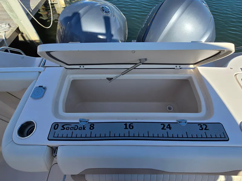 Slide: The Image of Open storage compartment on 2014 Grady-White Freedom 307 boat with SeaDek ruler. - 24