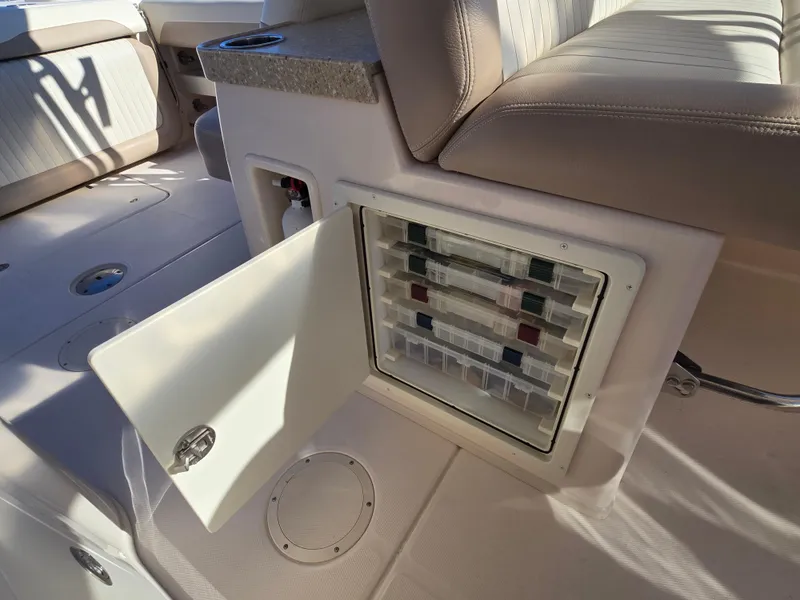 Slide: The Image of 2014 Grady-White Freedom 307 boat interior with open storage compartment. - 25