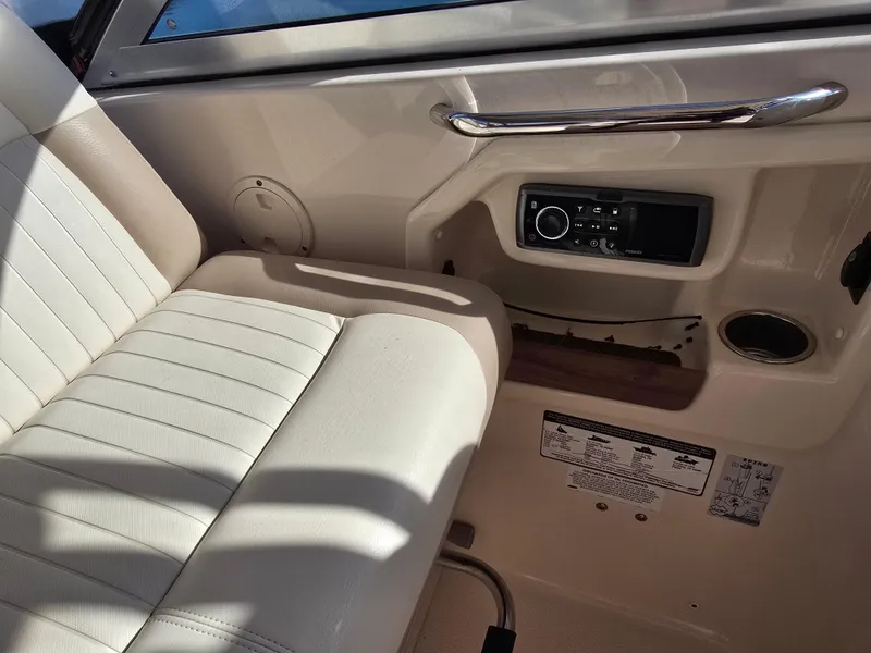 Slide: The Image of Interior of 2014 Grady-White Freedom 307 boat with beige seating and control panel. - 30