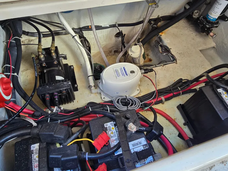 Slide: The Image of 2014 Grady-White Freedom 307 boat engine compartment with wiring and battery components. - 31
