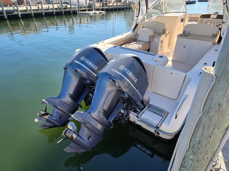 Slide: The Image of 2014 Grady-White Freedom 307 boat with twin Yamaha outboard engines docked in marina. - 32