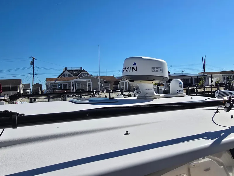 Slide: The Image of 2014 Grady-White Freedom 307 boat with Garmin radar, docked near waterfront homes. - 33