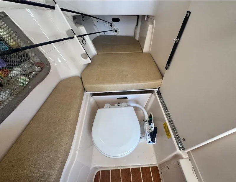 Slide: The Image of 2014 Grady-White Freedom 307 boat interior with seating and marine toilet. - 37