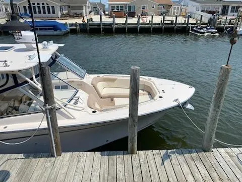 Slide: The Image of 2014 Grady-White Freedom 307 boat docked at a marina. - 4