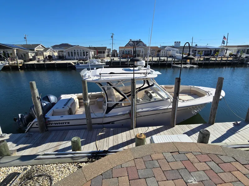 Slide: The Image of 2014 Grady-White Freedom 307 boat docked at a marina on a sunny day. - 5