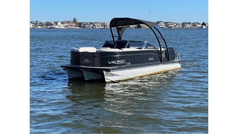 The Image of 2020 Avalon Catalina Platinum 2785 EL-W pontoon boat on a calm lake. - 0