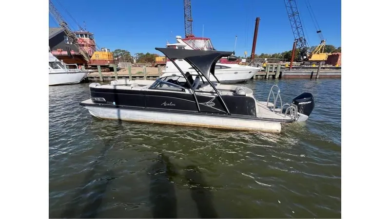 Slide: The Image of 2020 Avalon Catalina Platinum 2785 EL-W boat docked in a marina. - 2