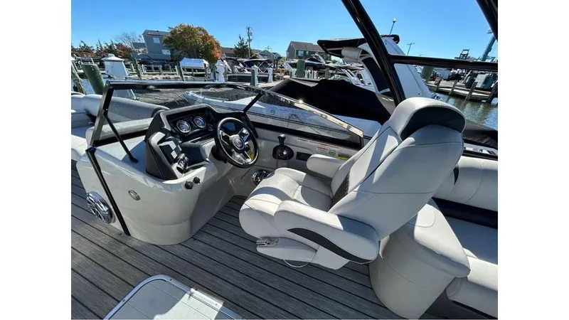 Slide: The Image of 2020 Avalon Catalina Platinum 2785 EL-W boat interior with sleek dashboard and comfortable seating. - 6