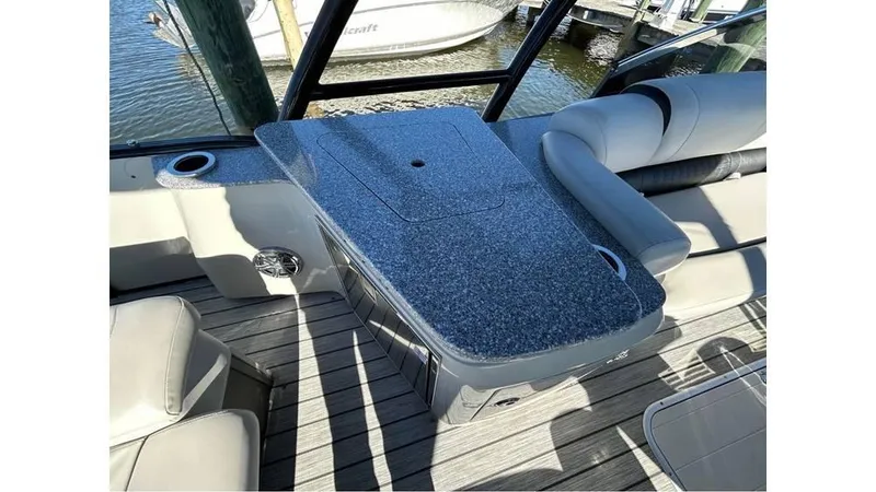 Slide: The Image of 2020 Avalon Catalina Platinum 2785 EL-W boat interior with sleek seating and table design. - 8