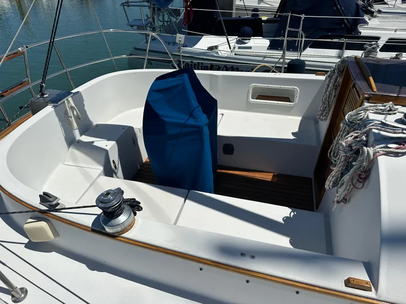 Slide: The Image of 1986 Nonsuch Ultra sailboat cockpit with covered helm, docked in marina. - 11