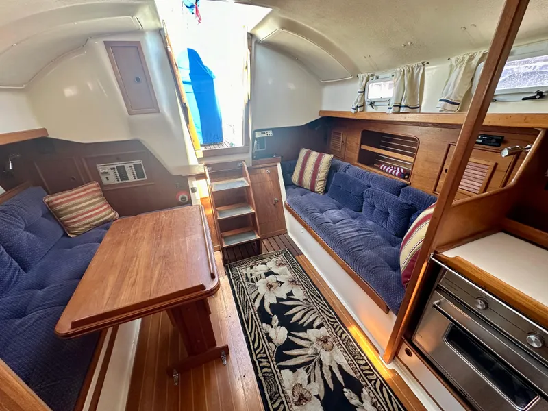 Slide: The Image of Interior of a 1986 Nonsuch Ultra sailboat with cozy seating and wooden finishes. - 4