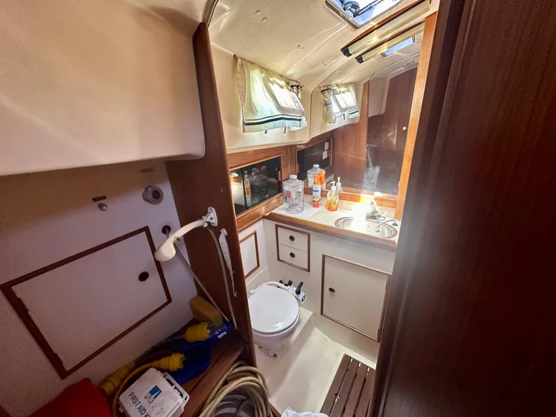 Slide: The Image of 1986 Nonsuch Ultra yacht bathroom with sink, toilet, and storage cabinets. - 8