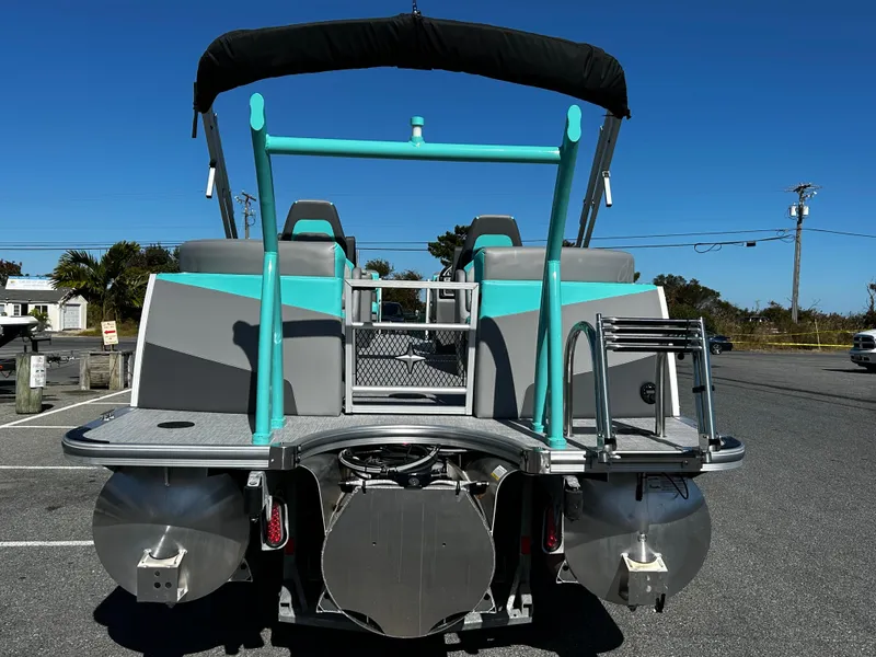 Slide: The Image of 2025 Berkshire 23RFX STS 3.0 pontoon boat, rear view, parked on asphalt. - 10