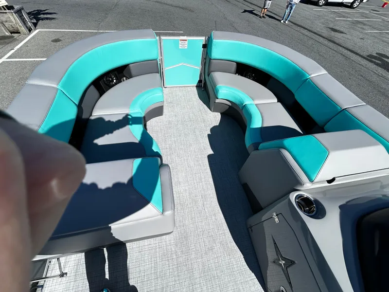Slide: The Image of 2025 Berkshire 23RFX STS 3.0 boat interior with teal and gray seating. - 14