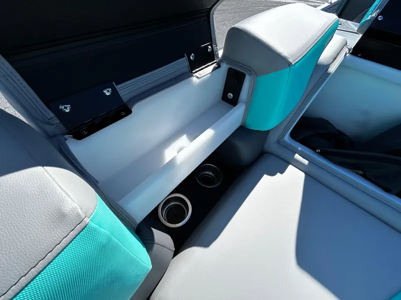 Slide: The Image of 2025 Berkshire 23RFX STS 3.0 boat interior with teal and gray seating, cup holders. - 15