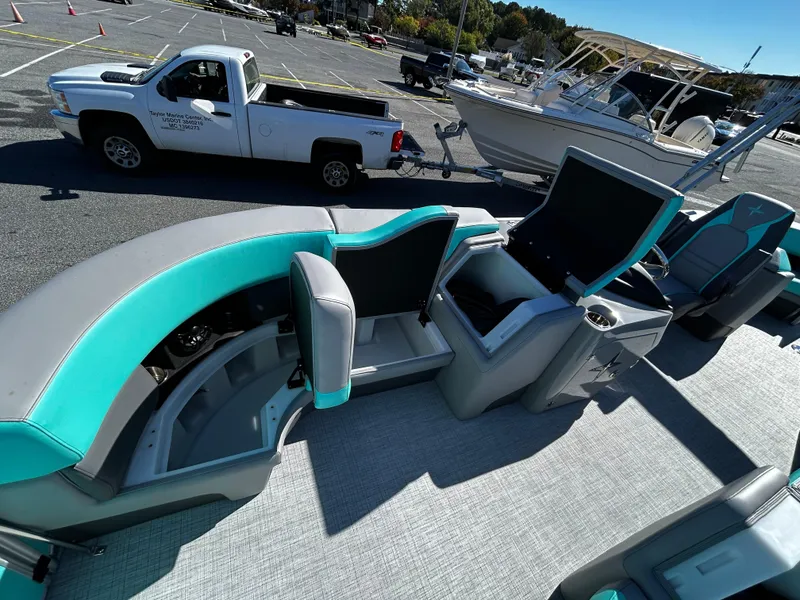 Slide: The Image of 2025 Berkshire 23RFX STS 3.0 pontoon boat interior with teal and gray seating. - 16