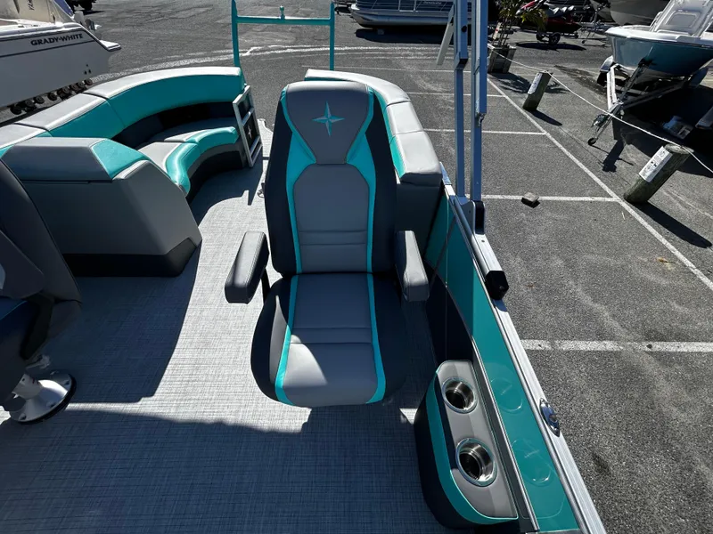 Slide: The Image of 2025 Berkshire 23RFX STS 3.0 boat interior with teal and gray seating. - 18