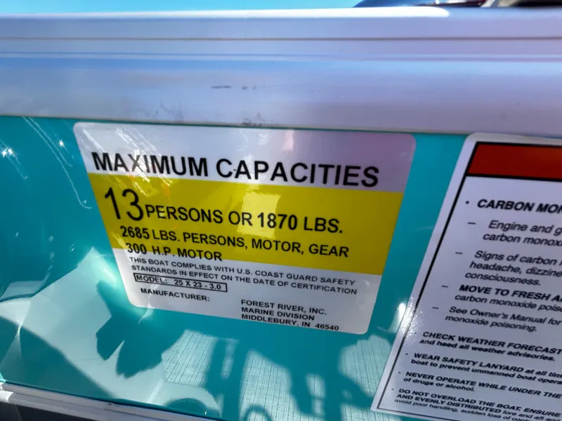 Slide: The Image of Capacity label on 2025 Berkshire 23RFX STS 3.0 boat, showing limits for persons and motor. - 25