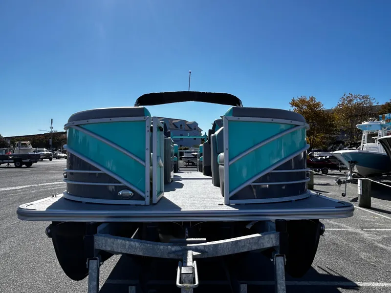 Slide: The Image of 2025 Berkshire 23RFX STS 3.0 pontoon boat on trailer in parking lot. - 4