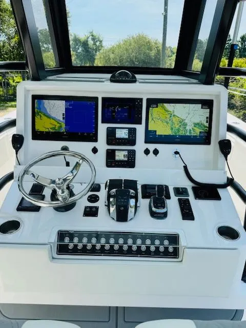 Slide: The Image of 2022 Invincible 36 Open Fisherman boat dashboard with advanced navigation and control systems. - 10