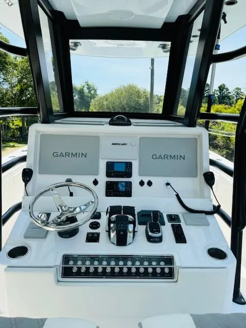 Slide: The Image of 2022 Invincible 36 Open Fisherman dashboard with Garmin navigation systems. - 21