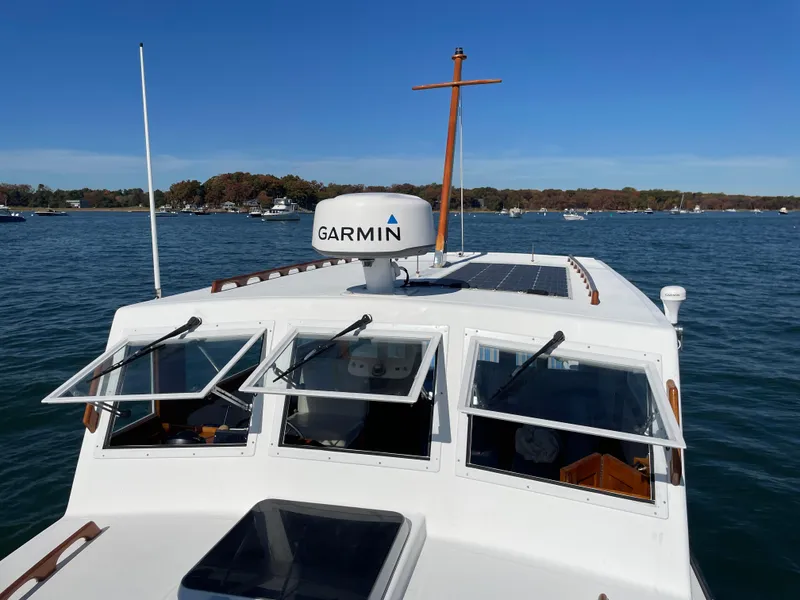 Slide: The Image of 1988 Ellis 28 boat with Garmin radar on calm water under clear blue sky. - 11