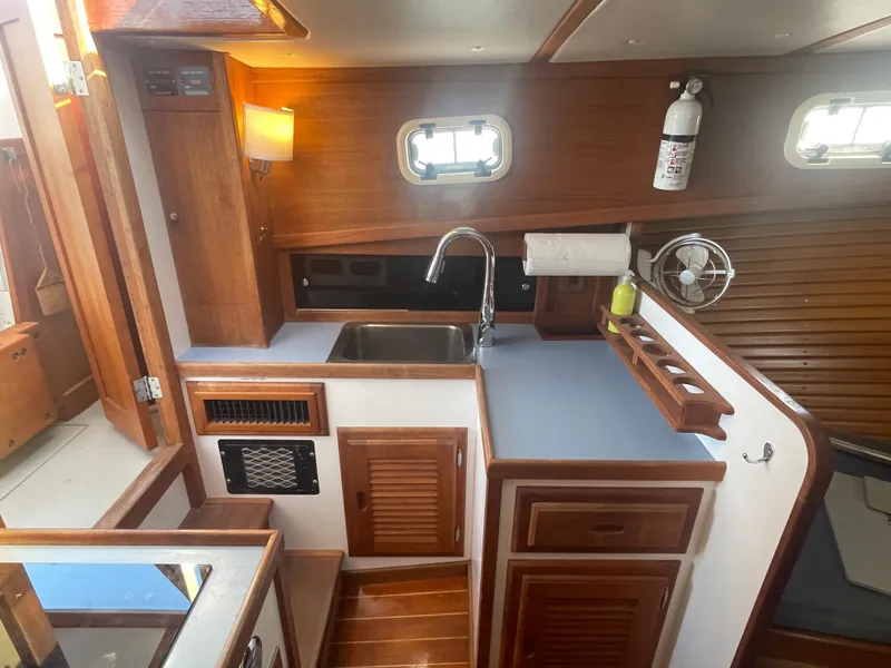 Slide: The Image of Cozy 1988 Ellis 28 boat kitchen with wooden cabinetry and modern amenities. - 23